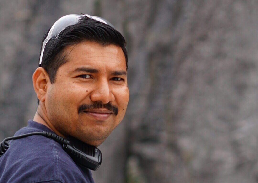 Portrait of Kavish Raj, crew member, smiling aboard a Maple Leaf Adventures ship.