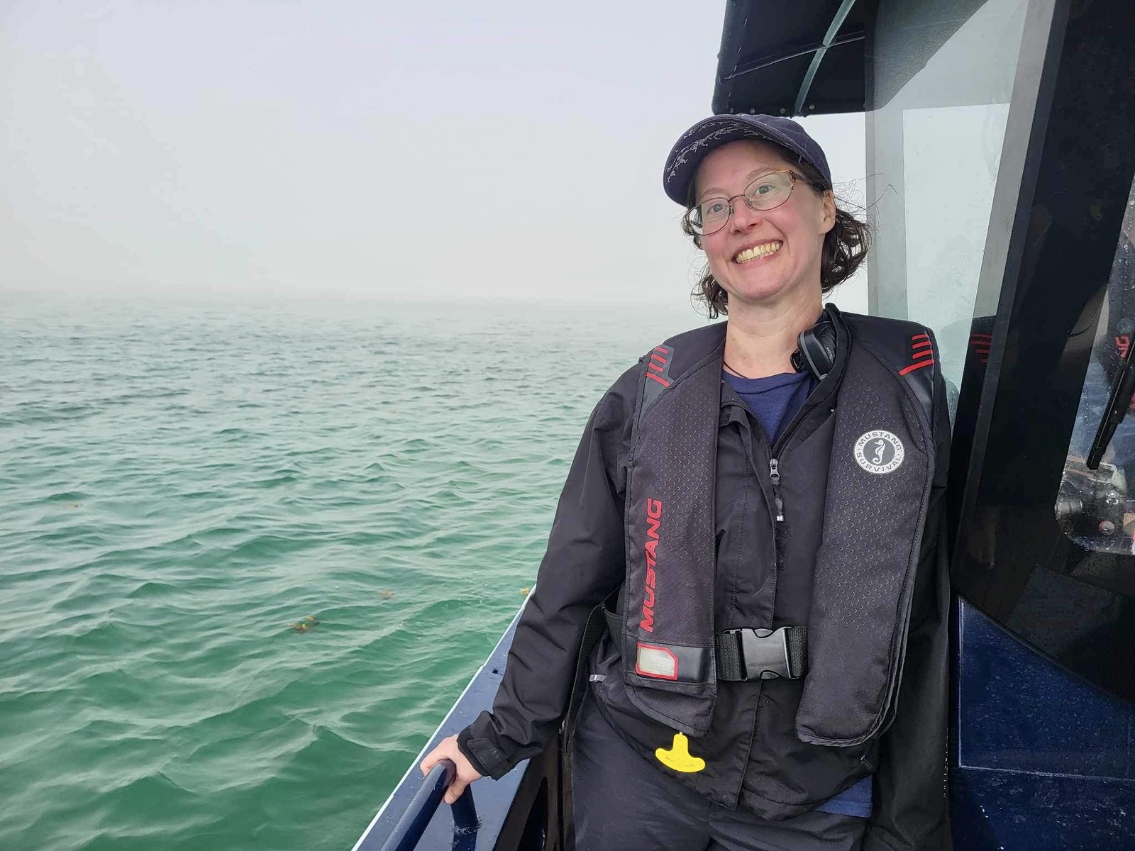 Leana Meyer, part of the Maple Leaf Adventures crew, smiling aboard a Cascadia tender.