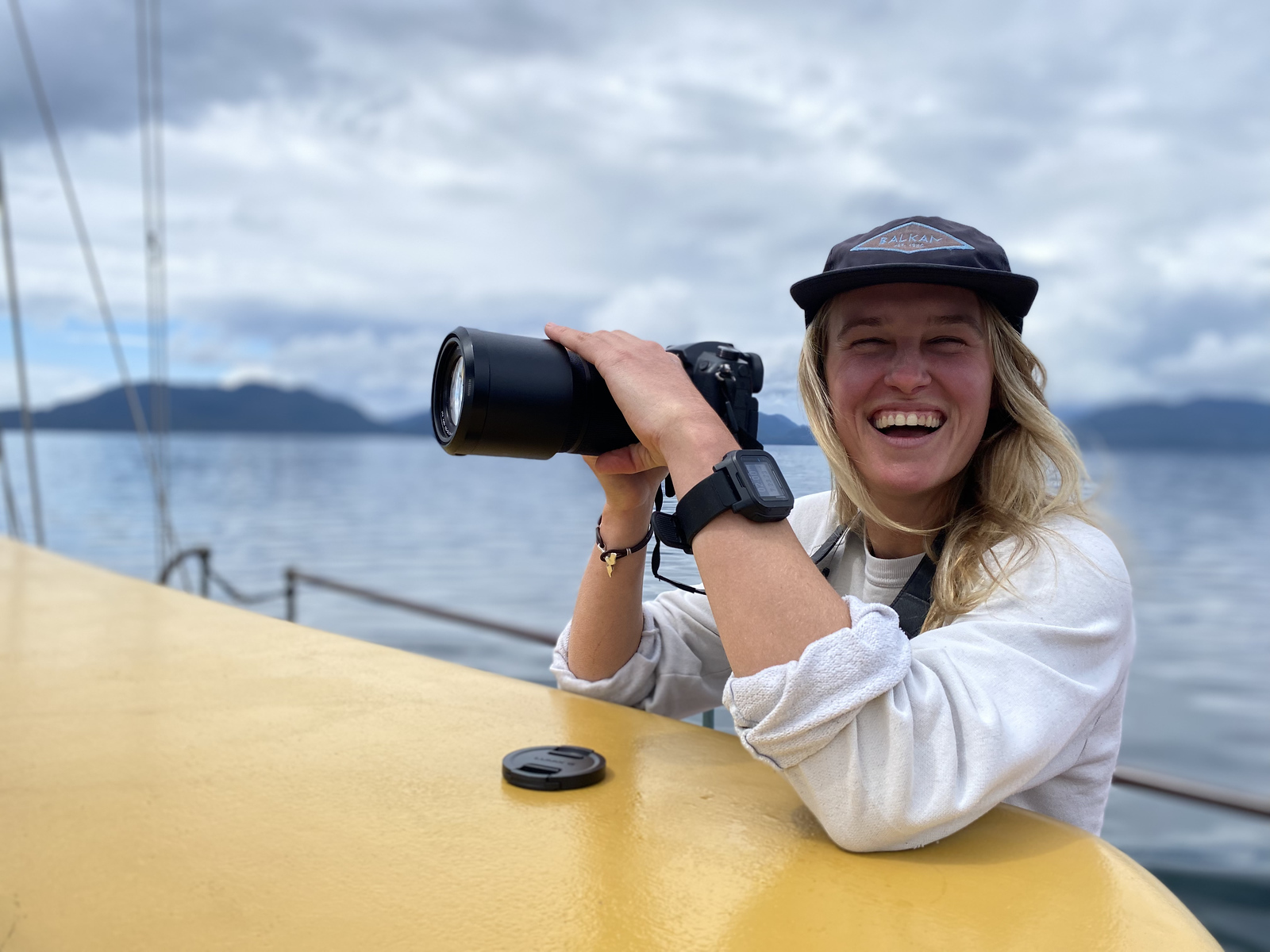 Sophie Vanderbanck, Maple Leaf Adventures crew, pictured at sea with camera in hand.