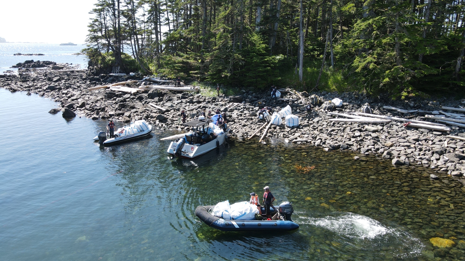 Tenders and Zodiac collecting debris during MDRI. Photo by Kevin Smith